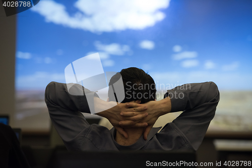 Image of young man dreaming clouds on presentation