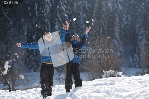 Image of kids playing with  fresh snow