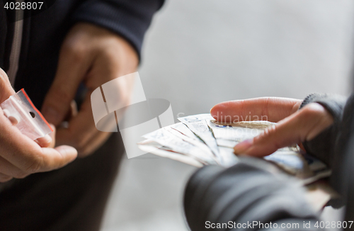 Image of close up of addict buying dose from drug dealer