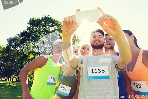 Image of teenage sportsmen taking selfie with smartphone