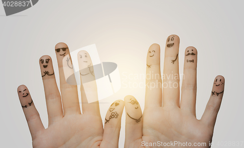 Image of close up of hands and fingers with smiley faces