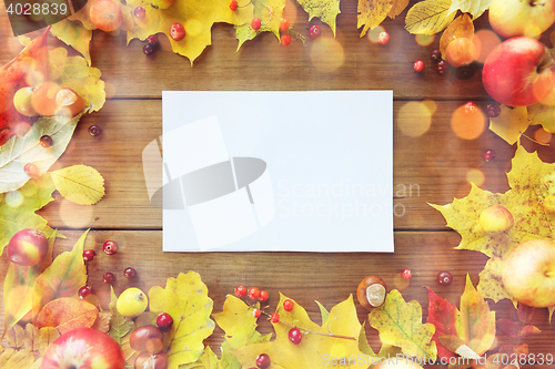 Image of close up of paper with autumn leaves and fruits