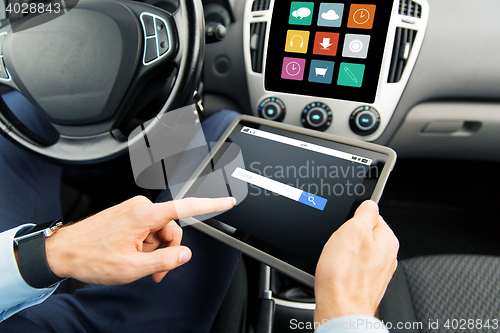 Image of close up of man with tablet pc in car