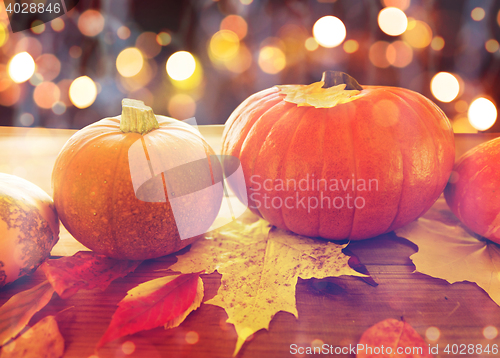 Image of close up of pumpkins on wooden table at home