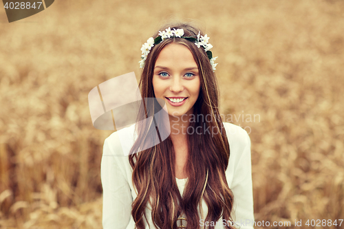 Image of smiling young hippie woman on cereal field