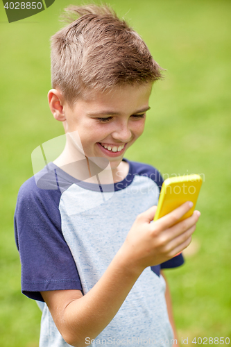 Image of boy with smartphone playing game in summer park