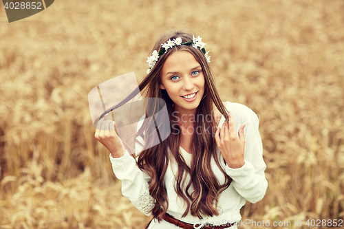 Image of smiling young hippie woman on cereal field