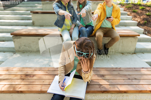 Image of student girl suffering of classmates mockery
