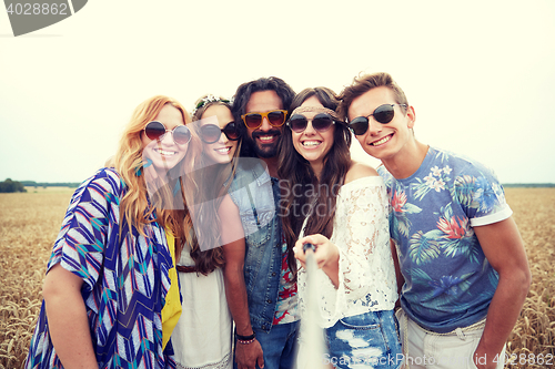 Image of smiling young hippie friends on cereal field