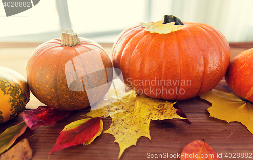 Image of close up of pumpkins on wooden table at home