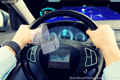 Image of close up of man driving car with graph on screen