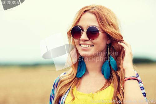 Image of smiling young redhead hippie woman outdoors