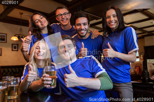 Image of football fans or friends with beer at sport bar