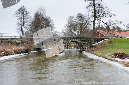 Image of old stonebridge over the cold water in sweden