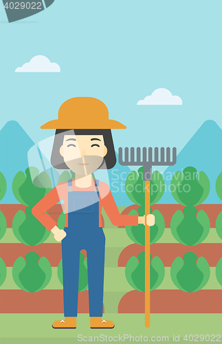 Image of Female farmer with rake vector illustration.