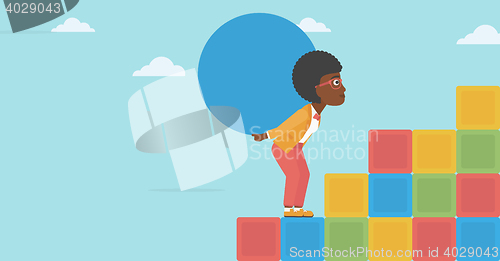 Image of Woman carrying concrete ball uphill.