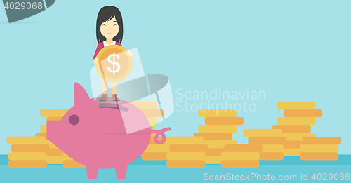 Image of Business woman putting coin in piggy bank.