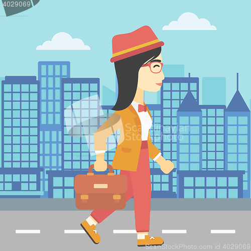 Image of Successful business woman walking with briefcase.