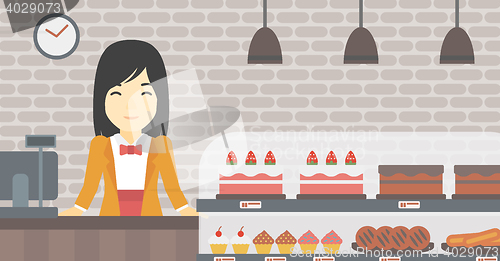 Image of Worker standing behind the counter at the bakery.