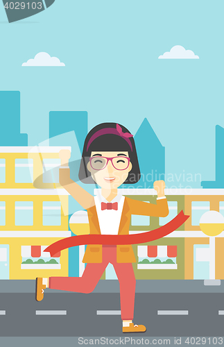 Image of Business woman crossing finish line.