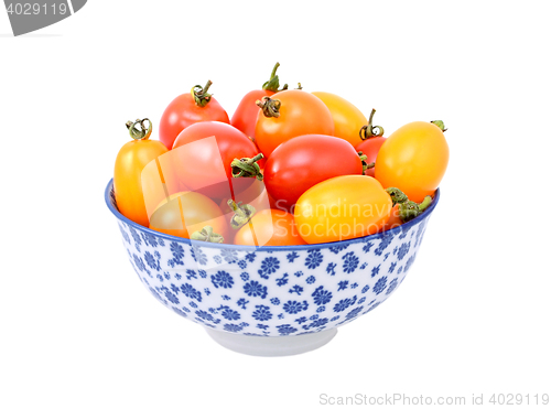Image of Red and yellow plum tomatoes in a blue and white china bowl