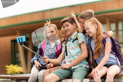 Image of happy elementary school students taking selfie