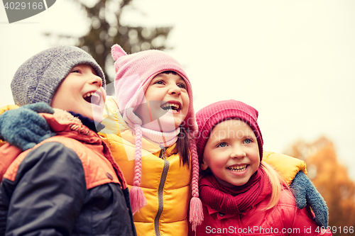 Image of group of happy children hugging in autumn park