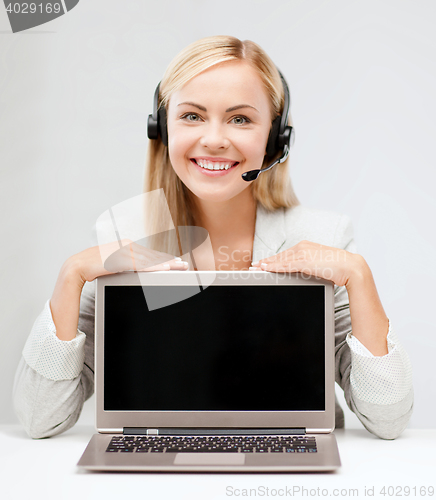 Image of smiling woman with headset and laptop computer