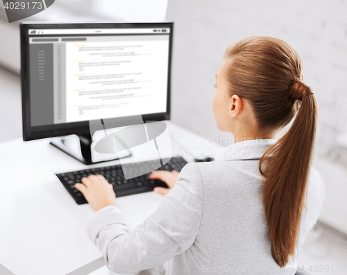 Image of businesswoman with coding on computer at office