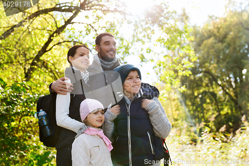 Image of happy family with backpacks hiking