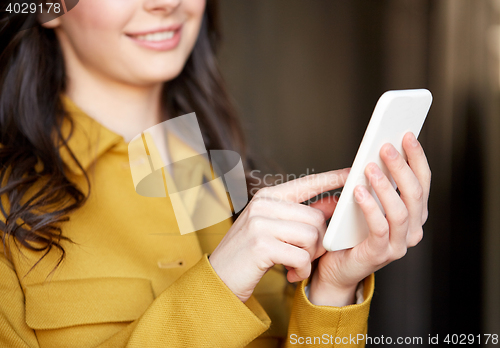 Image of close up of young woman or girl with smartphone