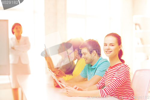 Image of female student with classmates in computer class