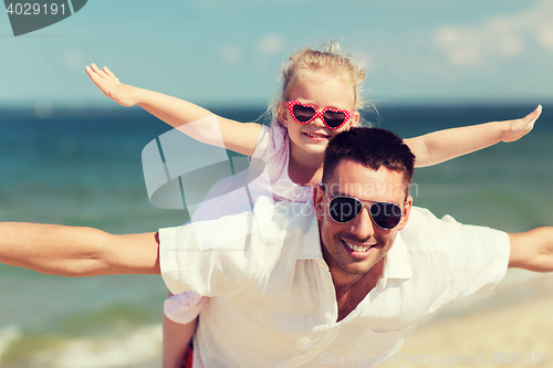 Image of happy family having fun on summer beach