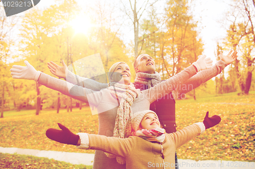 Image of happy family having fun in autumn park