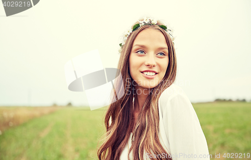 Image of smiling young hippie woman on cereal field