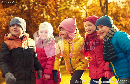 Image of group of happy children having fun in autumn park