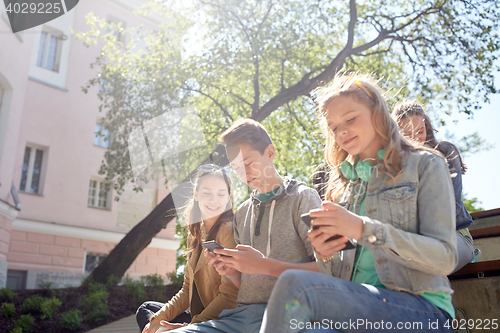 Image of teenage friends with smartphone and headphones