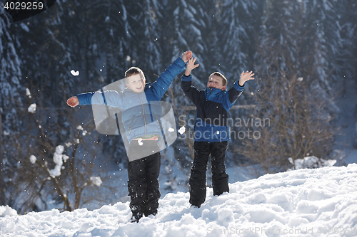 Image of kids playing with  fresh snow