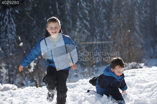 Image of kids playing with  fresh snow