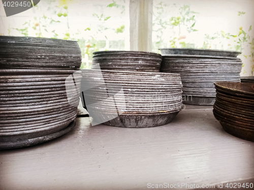 Image of Retro style metal plates for flower pots