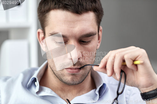 Image of portrait of businessman with eyeglasses at office