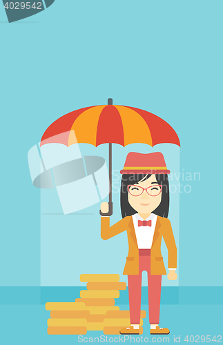 Image of Business woman with umbrella protecting money.