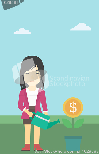 Image of Business woman watering money flower.