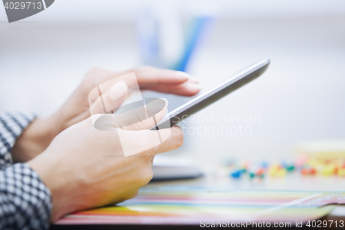 Image of Woman using digital tablet at office