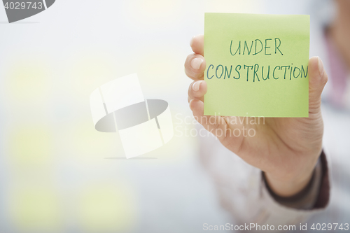 Image of Under construction text on adhesive note