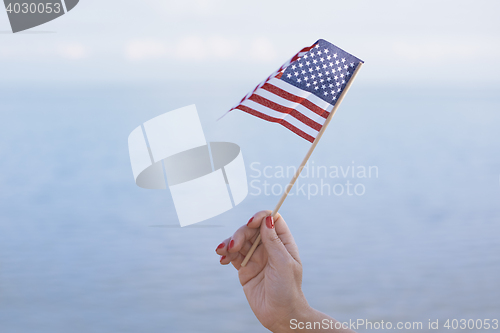 Image of Woman waving US flag