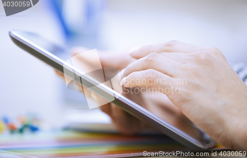 Image of Woman using digital tablet at office