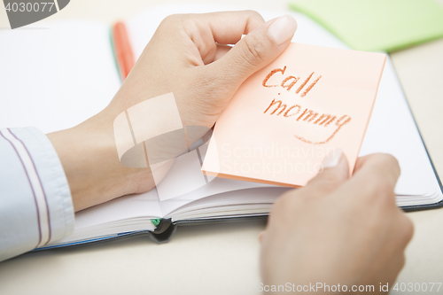 Image of Call mommy text on adhesive note