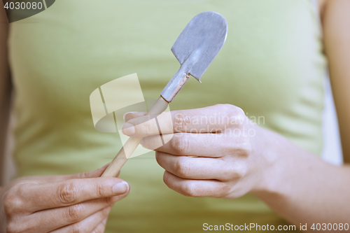 Image of Gardener with miniature shovel