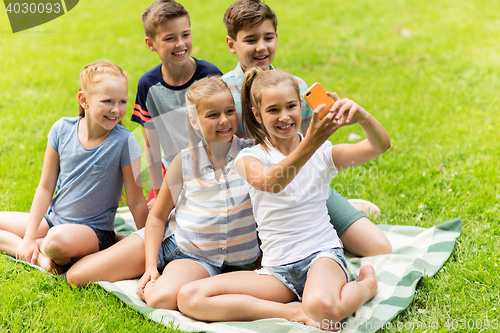 Image of happy kids or friends taking selfie in summer park